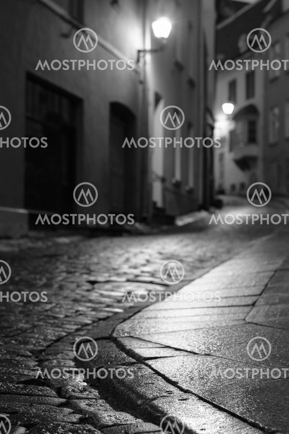 Illuminated night city street of old european town