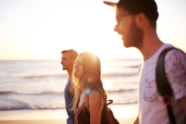 Smile, friends and walking on beach outdoor with travel...