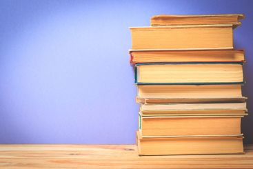 Vintage old books on wooden deck table