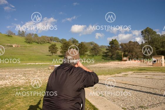looking over the skeet shooters shoulder