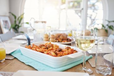 Interior, dining table and pasta with food in home for...