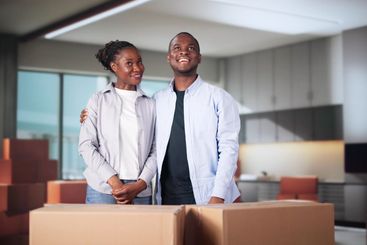 Happy Young Couple Moving Boxes