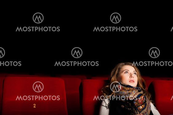 young attractive woman sitting in a cinema