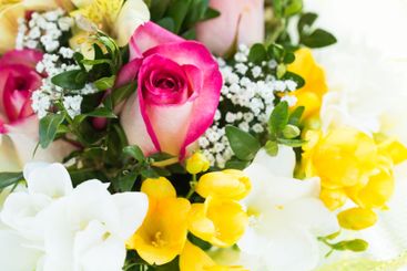 Colorful floral arrangement featuring roses, yellow...