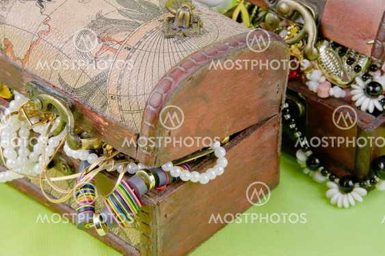 two small boxes with treasures on a light green background