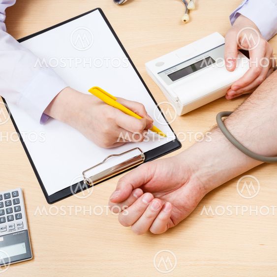 doctor measures blood pressure of patient