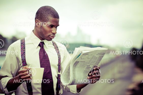 Businessman reading newspaper