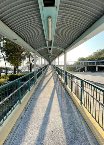 Perspective angle view of human bridge with sunlight and...