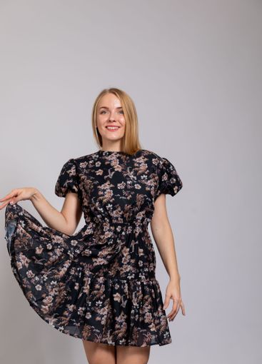 Beautiful woman smiling in summer dress on gray background