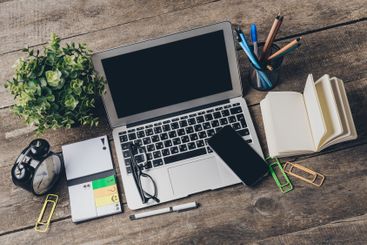 Productive workspace arrangement with laptop,...