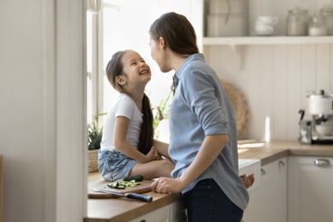 Busy active young woman cook food playing with little...