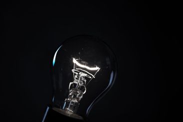 Close-up of electrical bulb on black background