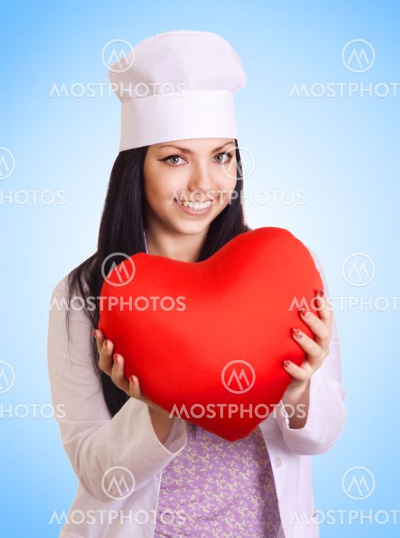 Female doctor holding heart on blue background