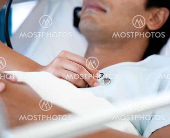 Close-up of a patient examinated by a doctor on a medical bed