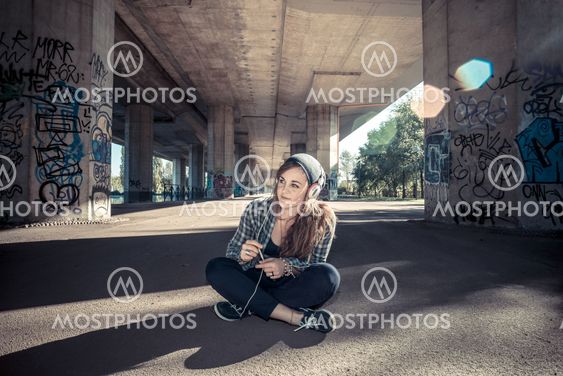 beautiful young blonde hipster woman listening music