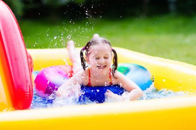 Little girl in garden swimming pool