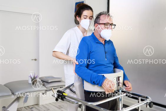 Physiotherapist assisting a patient with Amyotrophic...