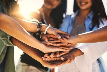 Hands together, support and closeup with friends...