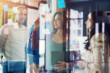 Business people, brainstorming or meeting with writing...