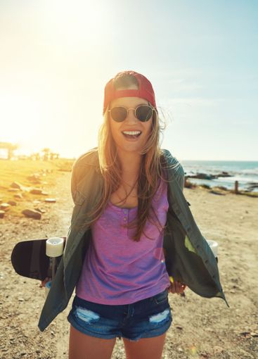 Vacation, beach and woman with skateboard, adventure and...