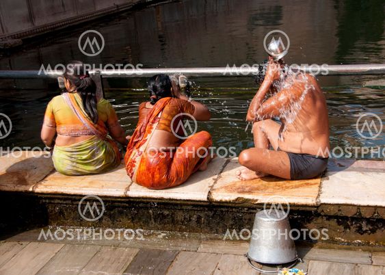 Three Hindu bathers at the Hanuman monkey temple outside India's Jaipur.