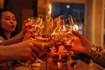 Female hands with champagne glasses. Young women make a...