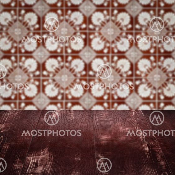 Wood table top and blur vintage ceramic tile pattern wall