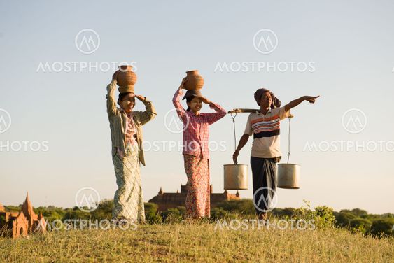 traditional asian farmer coming back from a harvest wheat field in bagan