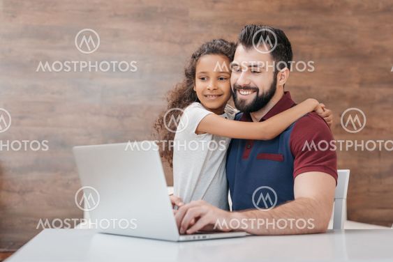 "happy father using laptop w..." av LightField - Mostphotos