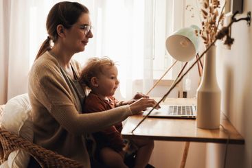 Woman working at home with her baby