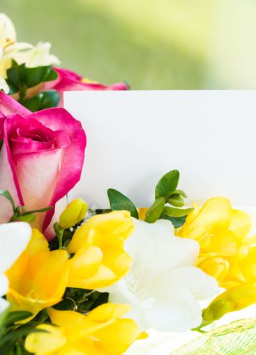 Colorful bouquet of flowers featuring pink roses, yellow...