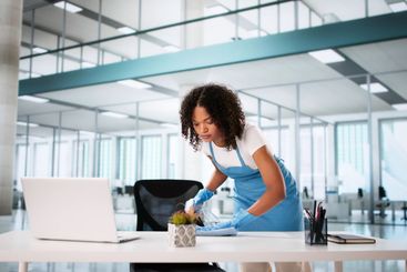 Janitor Cleaning Office Desk