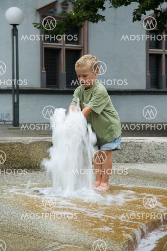 Boy Playing With Fountain