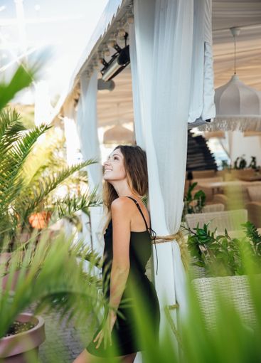 Beautiful fashionable woman in a black summer dress...