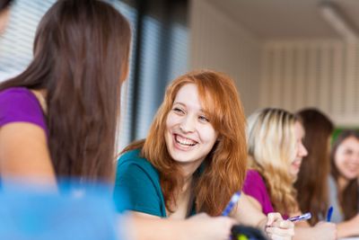 Students in a classroom during class (color toned image;...