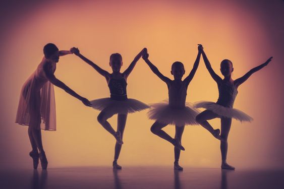 Three little ballerinas dancing with personal ballet...