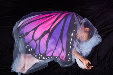 Teenage brunette girl in fetal position dressed in...