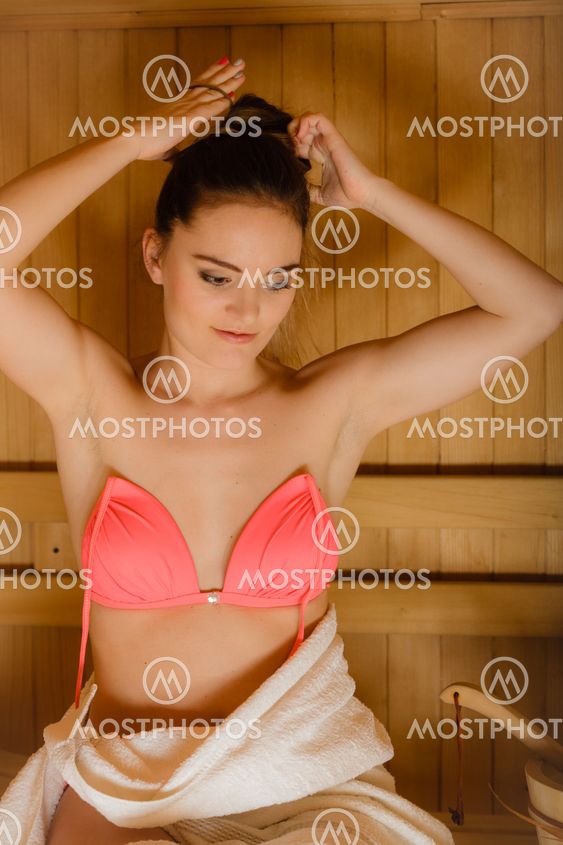 Portrait of woman relaxing in sauna. Spa wellbeing