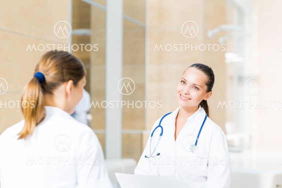 two doctors talking in the lobby of the hospital
