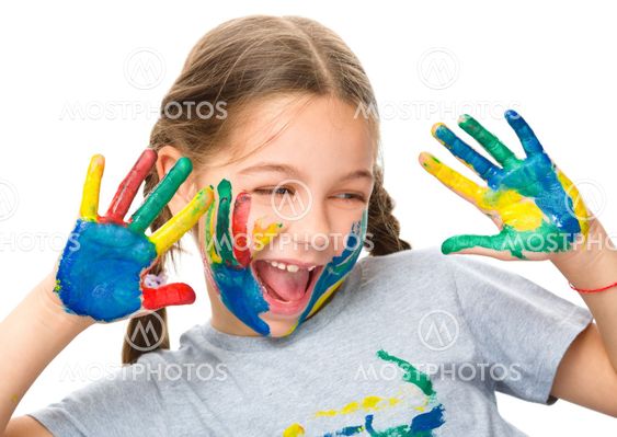 Portrait of a cute girl playing with paints