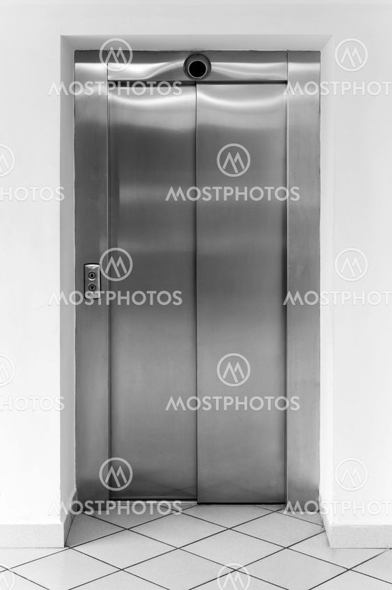 Modern office fragment, shining metal elevator doors