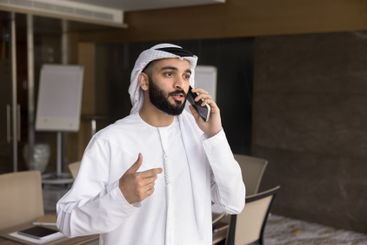 Arabian businessman dressed in traditional dishdasha...