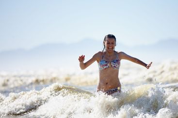 Swimming, waves or happy woman at sea for running on...