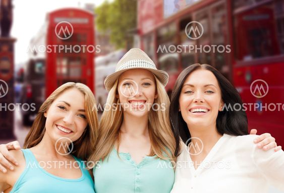 group of happy young women over london city street
