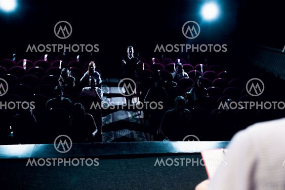 Male caucasian speaker giving presentation in hall at...