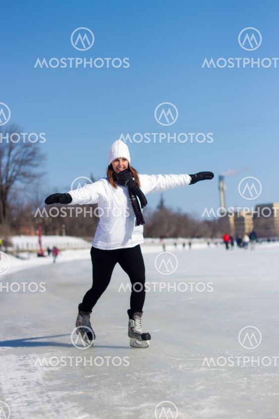 Young woman ice skating during winter