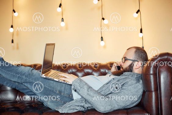 lifestyle successful freelancer man with beard achieves...