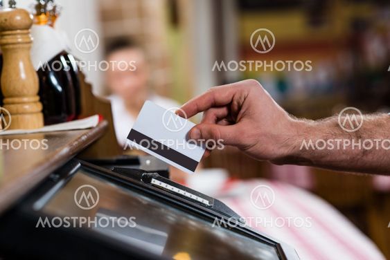 waiter inserts the card into a computer terminal