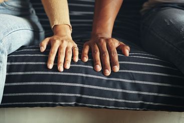 Couple, hands and breakup on couch, closeup and...