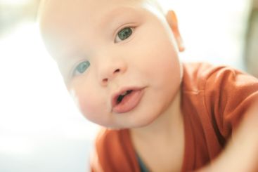 Baby boy, closeup portrait and home in morning sunshine...